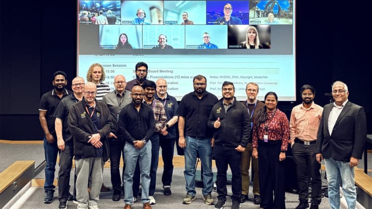 The 6G-ROCKET project team at its kick-off meeting at the University of Oulu, with remote partners joining on the screen behind them.