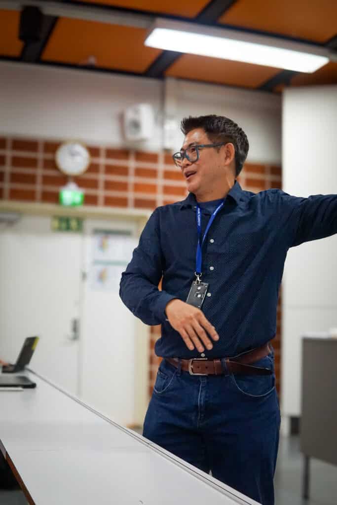 Attaphongse Taparugssanagorn presenting SmartWear AI research on wearable sensing, Tiny Machine Learning, and privacy-aware health monitoring.