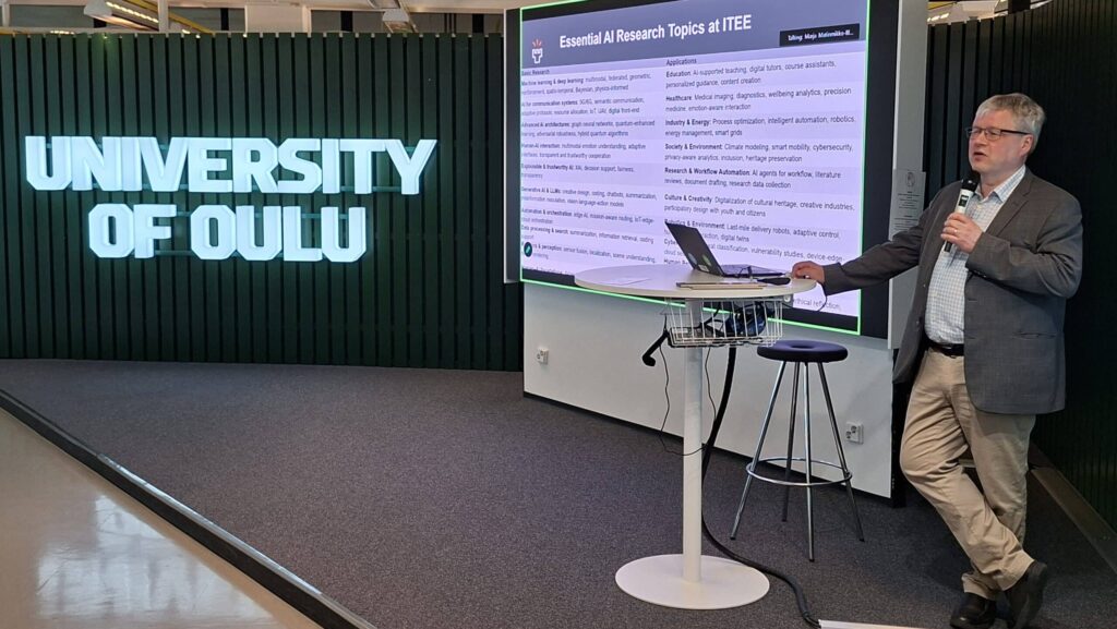 Jukka Riekki, Dean of the Faculty of Information Technology and Electrical Engineering at the University of Oulu, presents ITEE's AI research at the University of Oulu and NICT 6G workshop, Tellus Stage, 18 May 2026.