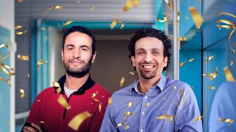 Professors Mehdi Bennis and Tarik Taleb celebrating their recognition as Highly Cited Researchers with gold confetti surrounding them.