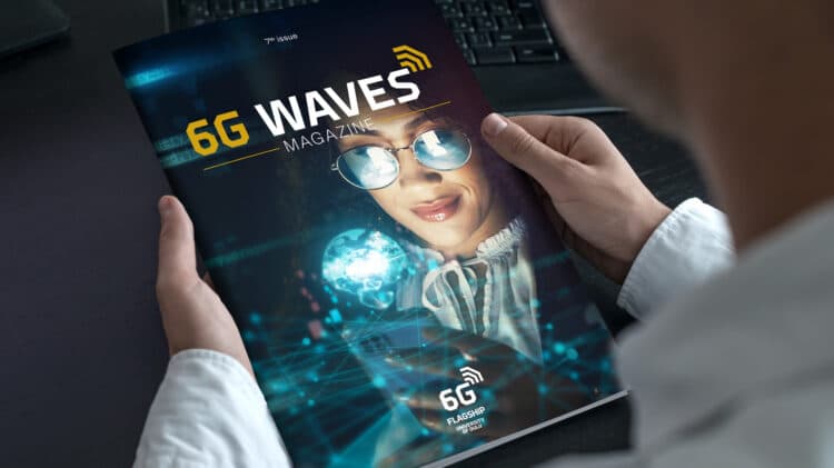 A person holding a copy of 6G Waves Magazine featuring a woman holding digital elements and the 6G Flagship logo of the University of Oulu.
