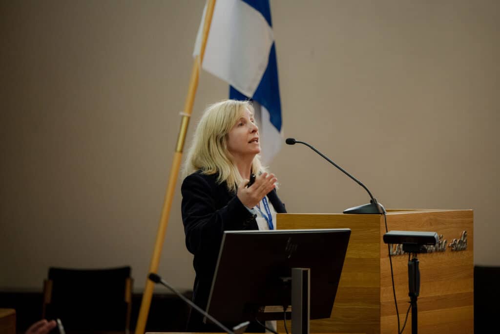 Sandra Dudley speaking on wireless sensing at a lectern